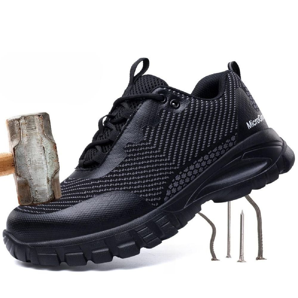 Baskets modernes noires pour homme avec semelle pneumatique et logo AIR.
