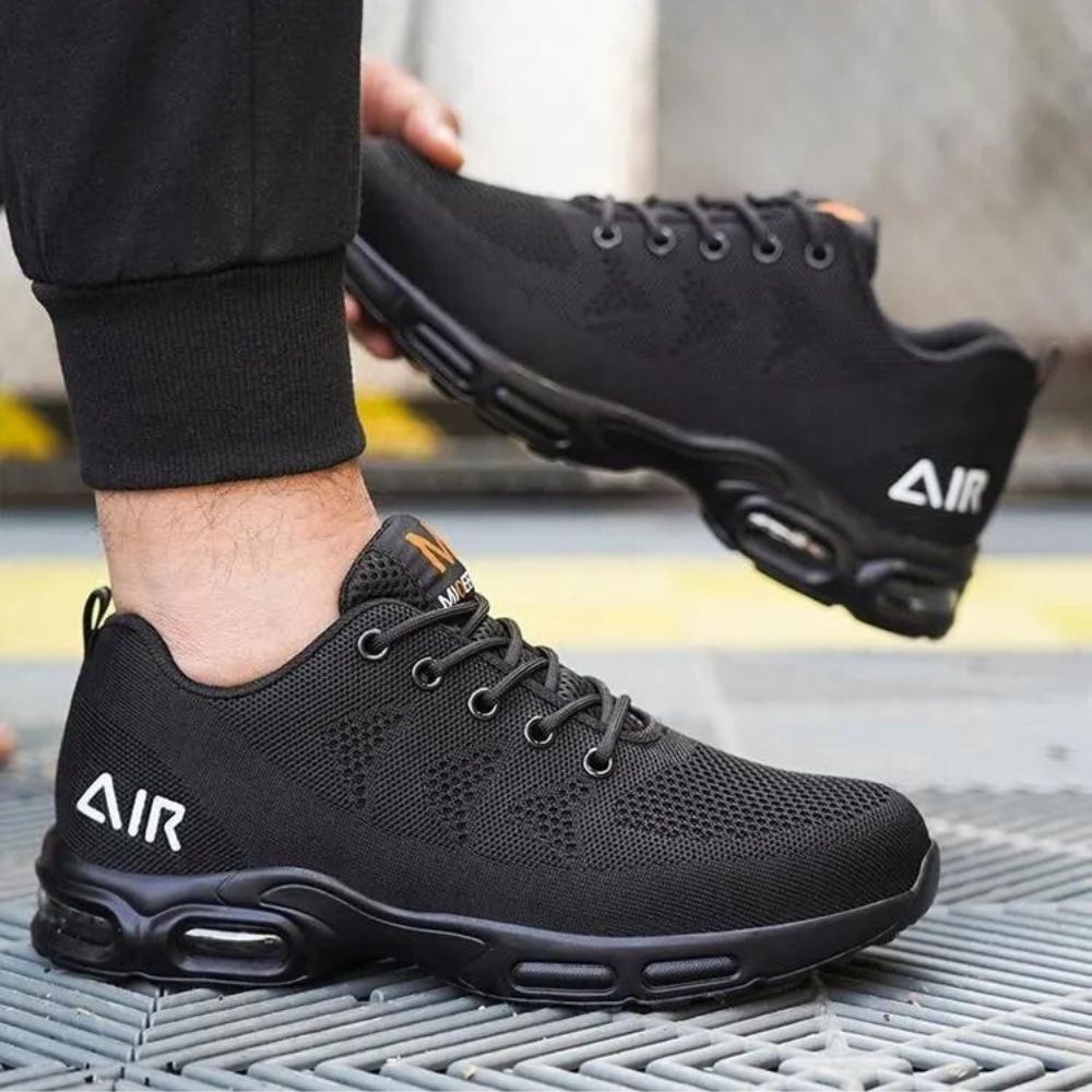 Baskets modernes noires pour homme avec semelle pneumatique et logo AIR.